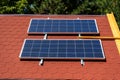 Solar panel on the roof of the house. Red tiles. Royalty Free Stock Photo
