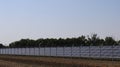solar panel station in a field behind a metal fence Royalty Free Stock Photo