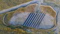 Solar panel station surrounded by a fence. View from a drone