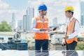 Solar panel technician on roof. Engineer and Young technician installing solar panels technology on factory roof Royalty Free Stock Photo