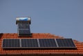 Solar panel  and vacuum air collectors for water heating on a red roof . Royalty Free Stock Photo