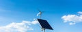 Solar panel and wind turbine panorama on sunny blue sky Royalty Free Stock Photo