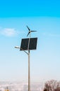 Solar panel, wind turbine under cloudy blue sky Royalty Free Stock Photo