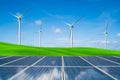 Solar panel and wind turbines farm on green hills Royalty Free Stock Photo