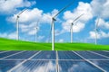 Solar panel and wind turbines farm on green hills Royalty Free Stock Photo