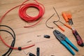 Solar panel wiring tools. Wire, connectors, crimping pliers on wooden floor Royalty Free Stock Photo