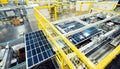 Solar panels on a conveyor belt in a modern industrial factory.