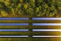 Solar panels aerial view among green trees in the forest Royalty Free Stock Photo