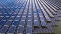 Solar panels in aerial view, rows array of polycrystalline silicon solar cells or photovoltaics in solar power plant floating on