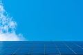 Solar panels on a background of blue sky and clouds. The concept of alternative energy. Advanced technologies for the production