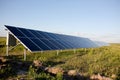 Solar panels, blue sky and green field. Royalty Free Stock Photo