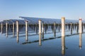 Solar panels and concrete columns over the fish pond