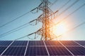 Solar panels with electricity pylon and sunset. Clean power ene Royalty Free Stock Photo