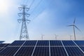 Solar panels with electricity pylon and wind turbine Clean power Royalty Free Stock Photo