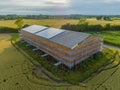 Solar panels on farm barn. Agriculture barn under renovation works with construction scaffolding frame. Currently renovated barn