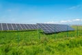 Solar panels in the field with blue sky produces renewable energy from the sun