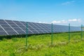 Solar panels in the field with blue sky produces renewable energy from the sun Royalty Free Stock Photo