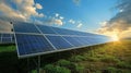 Solar Panels in Fields Under Bright Sky at Sunrise with Clouds Royalty Free Stock Photo