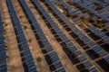 Solar panels in a flat desert terrain, aerial view. Generative AI Royalty Free Stock Photo