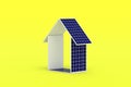 Solar panels in form of house on yellow background. Energy efficiency, autonomy