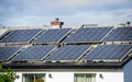 Solar panels installed on a house roof, harnessing renewable energy from sunlight to power households Royalty Free Stock Photo