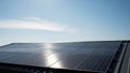 Solar panels installed on rooftop under clear blue sky Royalty Free Stock Photo