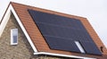 Solar panels mounted on the red rooftop of a modern new-build house in the Netherlands Royalty Free Stock Photo