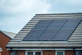 Solar Panels Mounted On The Roof Of A Modern New-build House In England UK