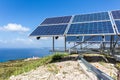 Solar panels near blue sea and monastery Royalty Free Stock Photo