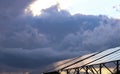 Solar panels Photoelectric elements on the background of dark storm clouds, the sky, approaching stormy rain clouds. Royalty Free Stock Photo