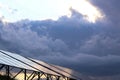 Solar panels Photoelectric elements on the background of dark storm clouds, the sky, approaching stormy rain clouds. Royalty Free Stock Photo