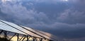 Solar panels Photoelectric elements on the background of dark storm clouds, the sky, approaching stormy rain clouds. Royalty Free Stock Photo