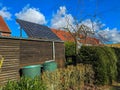 Solar panels of photovoltaic powerplant at the roof of a shed in the garden