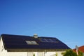 Solar panels on a residential building roof in the blazing sunshine