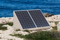 Solar panels on the rocks on the seashore. Nature-friendly energy production, a symbol of nature protection