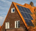 Solar panels on the roof, dutch house with orange tiles and photovoltaic panels Royalty Free Stock Photo