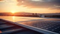 Solar panels on the roof of a house against the background of the setting sun. Photovoltaic modules for renewable electric energy Royalty Free Stock Photo