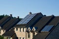 Solar panels on the roof of a house on a sunny day with green trees in the background Royalty Free Stock Photo