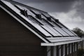 Solar panels on the roof of modern new-build homes in the Netherlands on a heavily overcast day Royalty Free Stock Photo