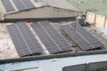 Solar panels on roof top of an old building showing the concept of adapting eco-friendly energy resources