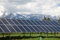 Solar panels with snowy mountains in the background