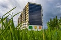 solar panels on the wall of a multi-storey building on green trees background. Renewable solar energy Royalty Free Stock Photo