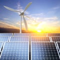 Solar panels and wind turbine against the sunset. Alternative energy concept Royalty Free Stock Photo