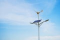 Solar panels and wind turbine and blue sky background Royalty Free Stock Photo