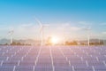 Solar panels with wind turbines against blue sky background Royalty Free Stock Photo