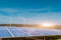 Solar panels with wind turbines against blue sky background Royalty Free Stock Photo