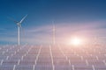 Solar panels with wind turbines against blue sky background Royalty Free Stock Photo