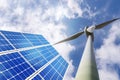 Solar panels and wind turbines with blue sky