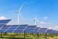 Solar panels and wind turbines in hybrid power plant systems station Royalty Free Stock Photo