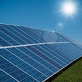 Solar power plant panels with sun rays and blue sky Royalty Free Stock Photo